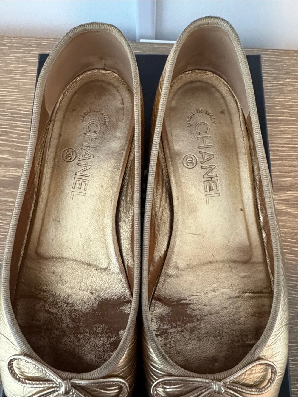 CHANEL Gold Leather Ballet Flats with Black Cap-Toe